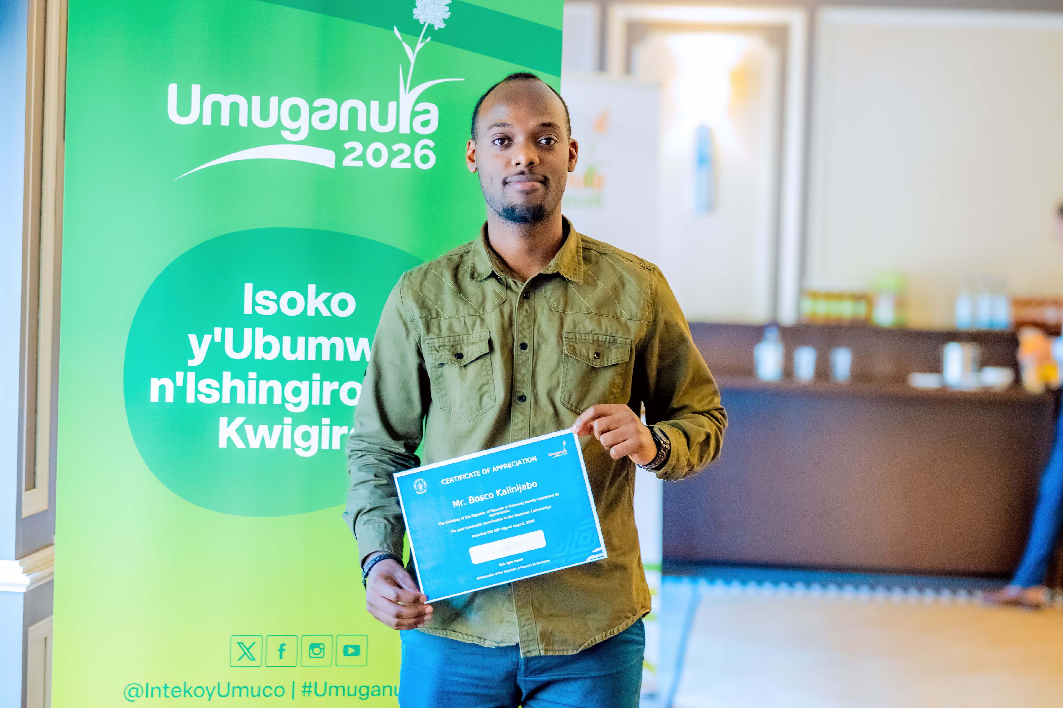 Bosco Kalinijabo receiving appreciation at Umuganura